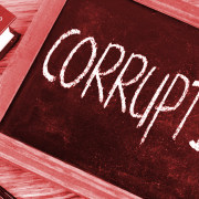 The word 'corruption' written in chalk on a small chalkboard