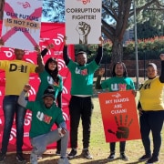 YOung people holding anti-corruption placards